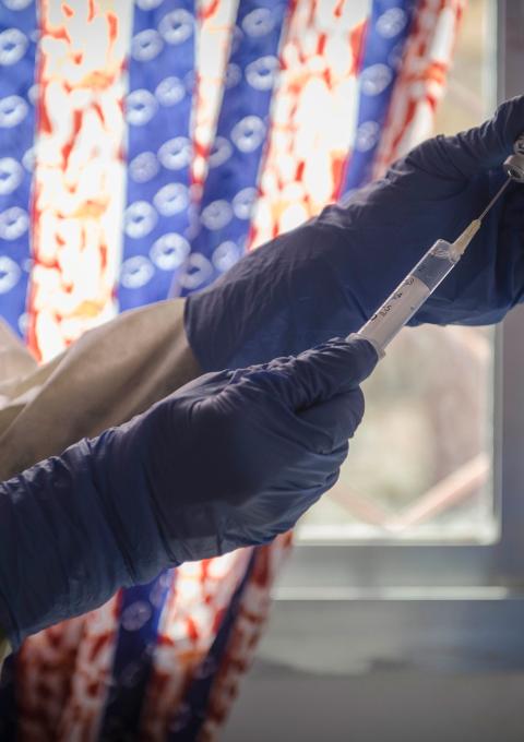 MSF staff prepares a dose of an experimental vaccine